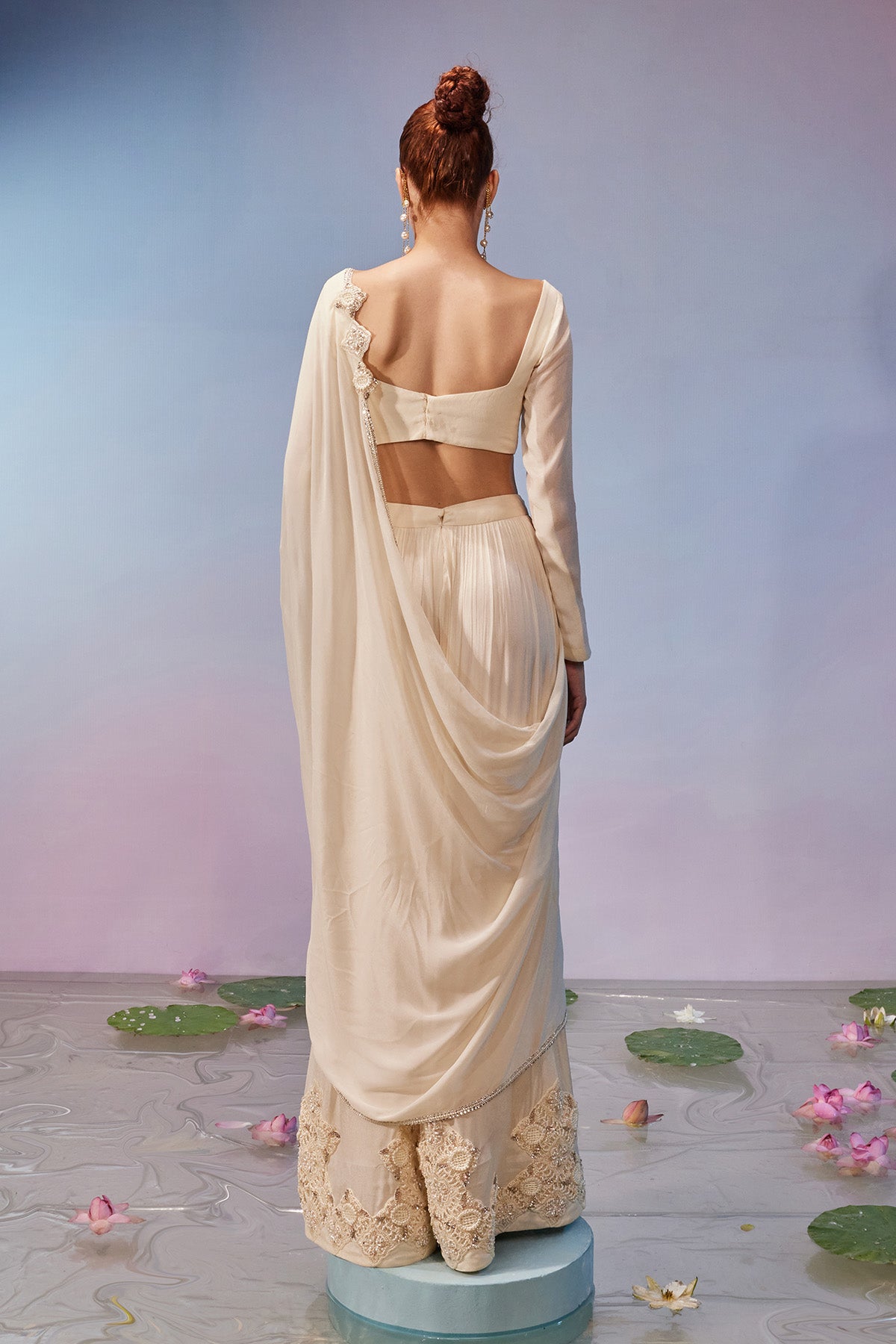 Full sleeve necklace style blouse teamed with embroidered sharara pant & dupatta